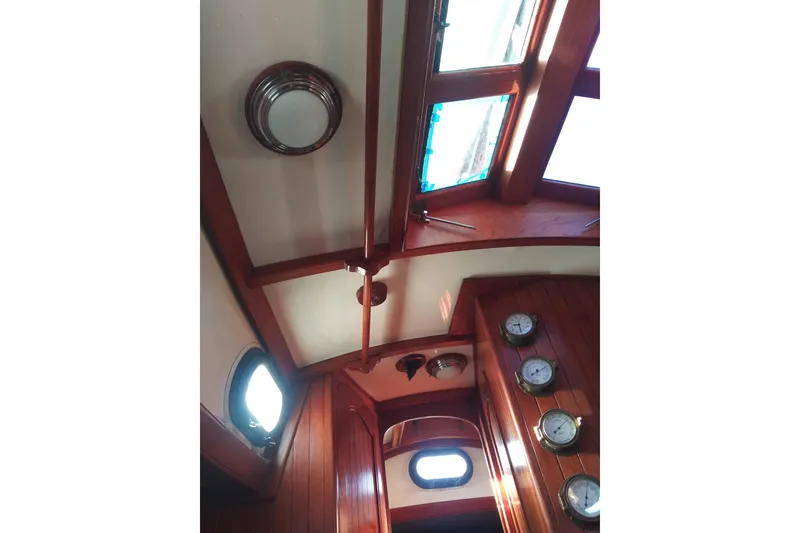 Slide: The Image of Interior view of a 1978 Baba Cutter yacht with wooden finish. - 3