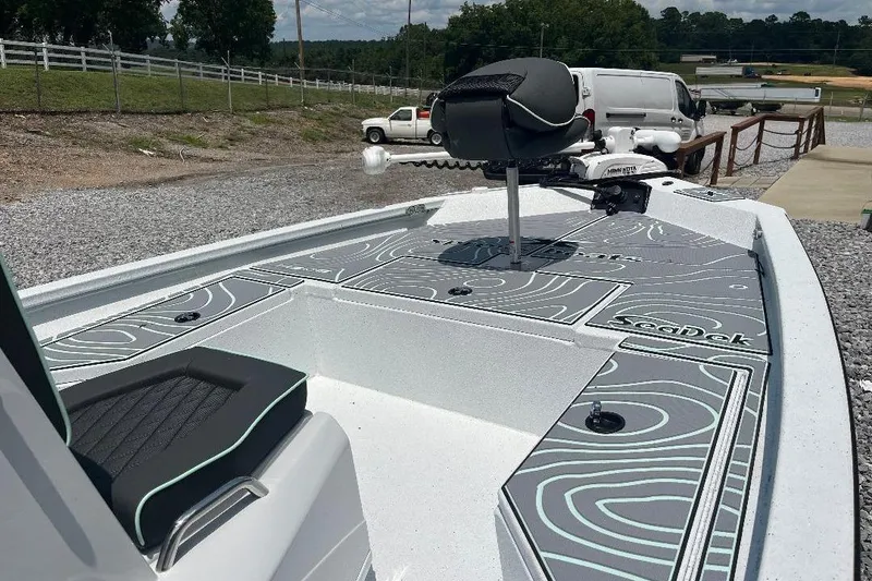 Slide: The Image of 2026 Xpress H20 BAY boat with SeaDek flooring, parked outdoors. - 6
