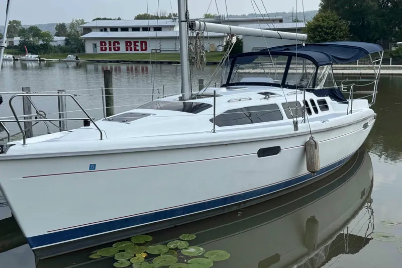 Slide: The Image of Sailboat Hunter 336, 1995 model, docked near a building labeled "Big Red." - 1