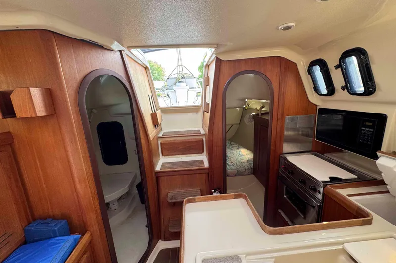 Slide: The Image of Interior of 1995 Hunter 336 sailboat with wood finish and compact kitchen area. - 20