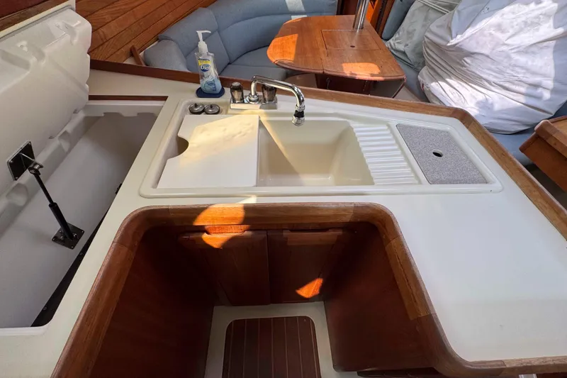 Slide: The Image of Interior of 1995 Hunter 336 sailboat kitchen with sink and wooden cabinetry. - 21