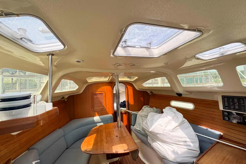 Slide: The Image of Interior of a 1995 Hunter 336 sailboat with wooden accents and skylights. - 24