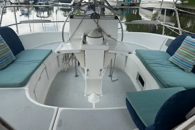Slide: The Image of Cockpit of 1995 Hunter 336 sailboat with cushioned seating and steering wheel. - 6