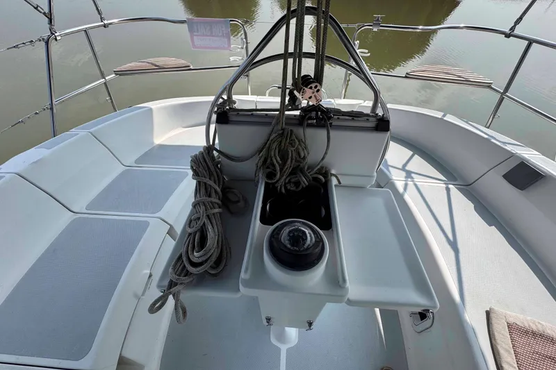Slide: The Image of Cockpit of 1995 Hunter 336 sailboat with ropes and compass, docked on calm water. - 7