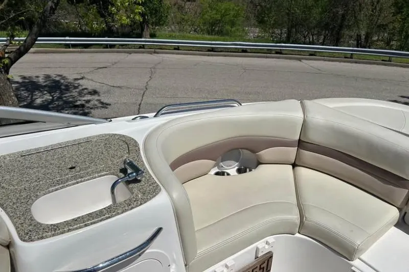Slide: The Image of 2005 Chaparral 256 SSi boat interior with beige seating and granite countertop. - 2
