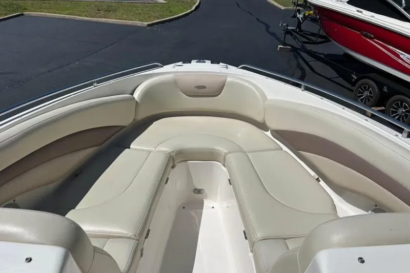 Slide: The Image of 2005 Chaparral 256 SSi boat interior with beige seating and sleek design. - 3