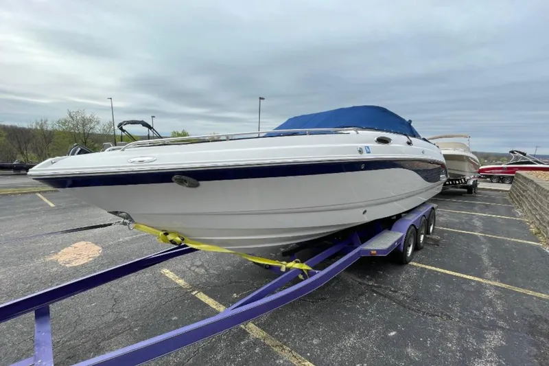 Slide: The Image of 2005 Chaparral 256 SSi boat on trailer in parking lot, overcast sky. - 5