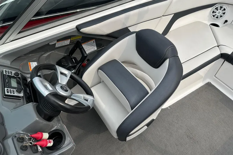 Slide: The Image of 2015 Yamaha AR210 boat interior with steering wheel and seating area. - 1