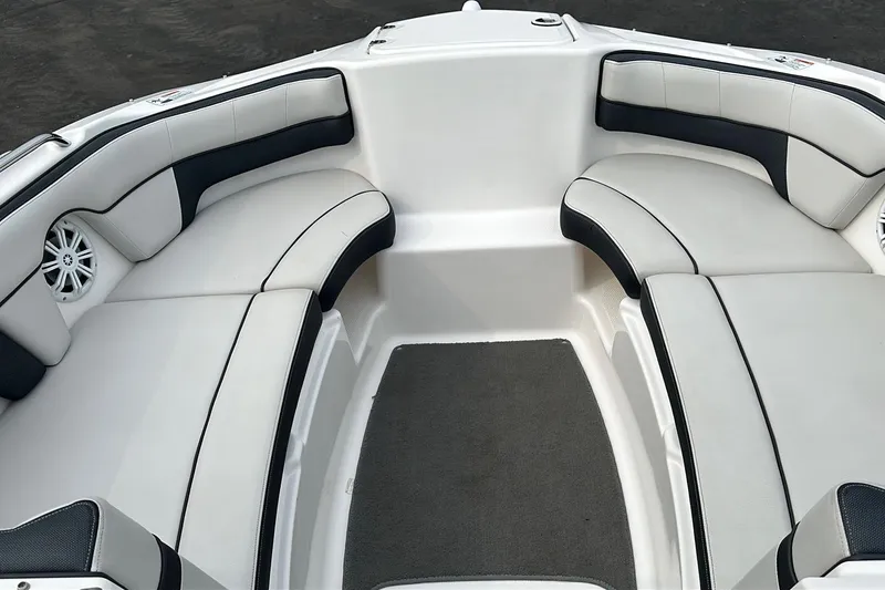 Slide: The Image of 2015 Yamaha AR210 boat interior with white and black cushioned seating. - 3
