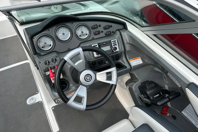 Slide: The Image of 2015 Yamaha Boats AR210 dashboard with steering wheel and control panel. - 4