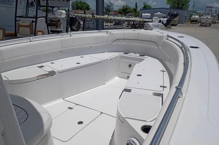 Slide: The Image of 2021 Sportsman Open 282 Center Console boat with cushioned seating and fishing rod holders. - 15