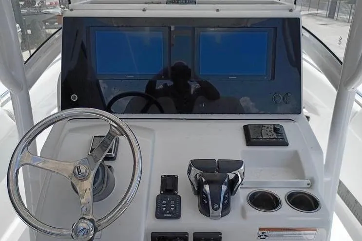 Slide: The Image of 2021 Sportsman Open 282 Center Console interior, featuring sleek white seating and storage compartments. - 8