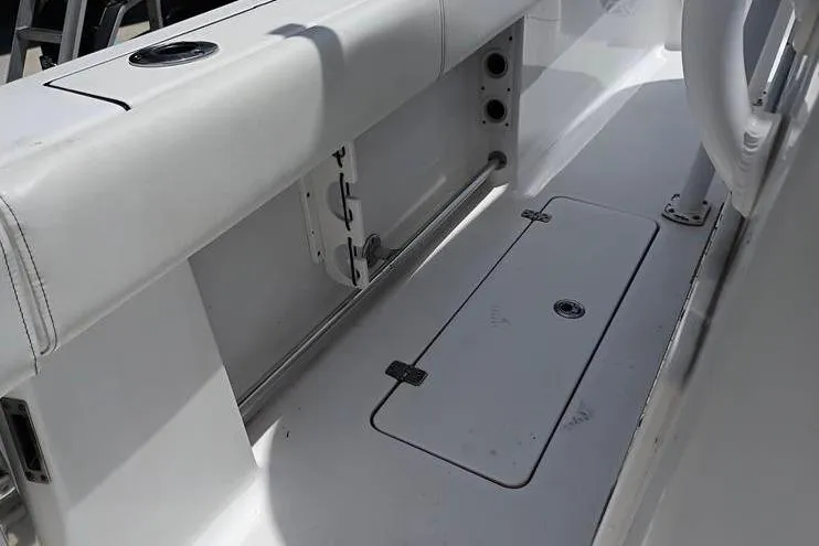 Slide: The Image of 2021 Sportsman Open 282 Center Console boat interior with rod holders and storage compartments. - 9