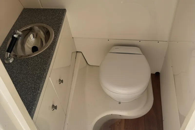 Slide: The Image of 2021 Robalo R317 Dual Console boat bathroom with sink and toilet. - 12