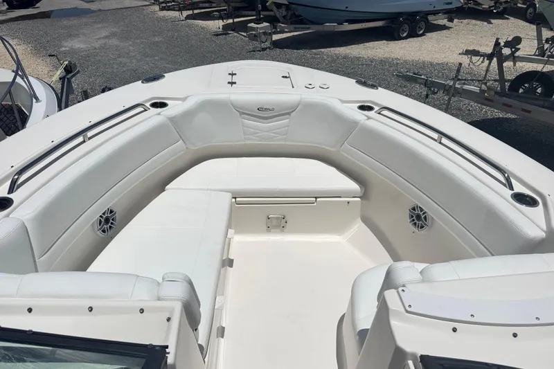 Slide: The Image of 2021 Robalo R317 Dual Console boat interior with white seating and cup holders. - 15
