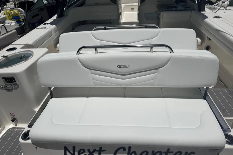 Slide: The Image of 2021 Robalo R317 Dual Console boat interior with white seating and sleek design. - 2