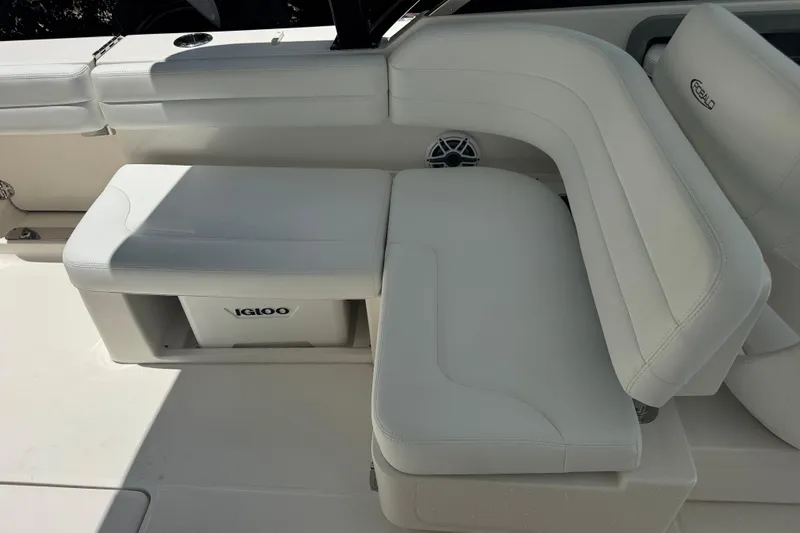 Slide: The Image of 2021 Robalo R317 Dual Console boat with white cushioned seating and Igloo cooler. - 21