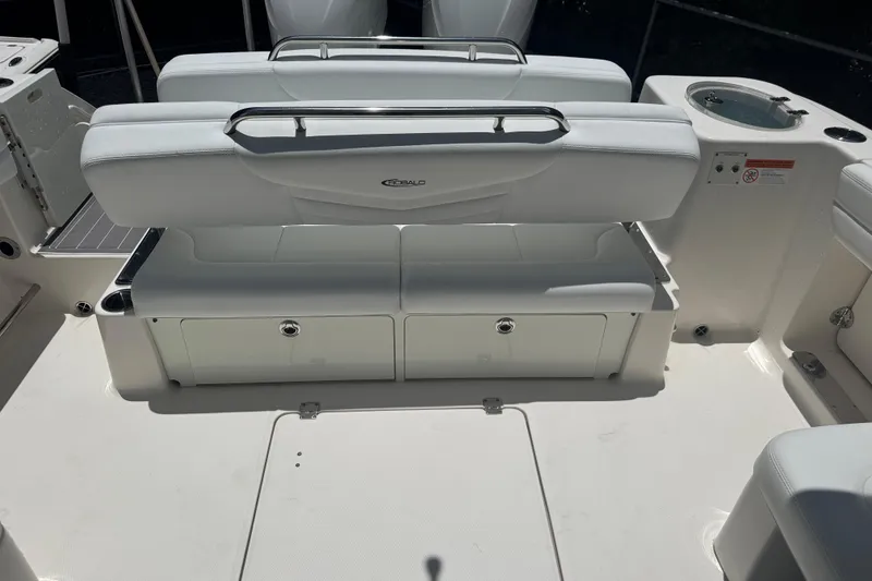 Slide: The Image of 2021 Robalo R317 Dual Console boat interior with white seating and storage compartments. - 22