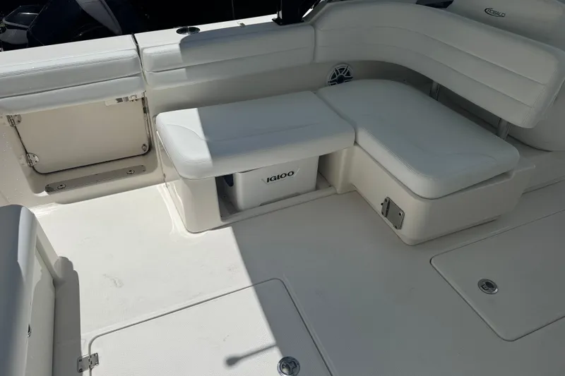 Slide: The Image of 2021 Robalo R317 Dual Console boat interior with white seating and storage. - 4