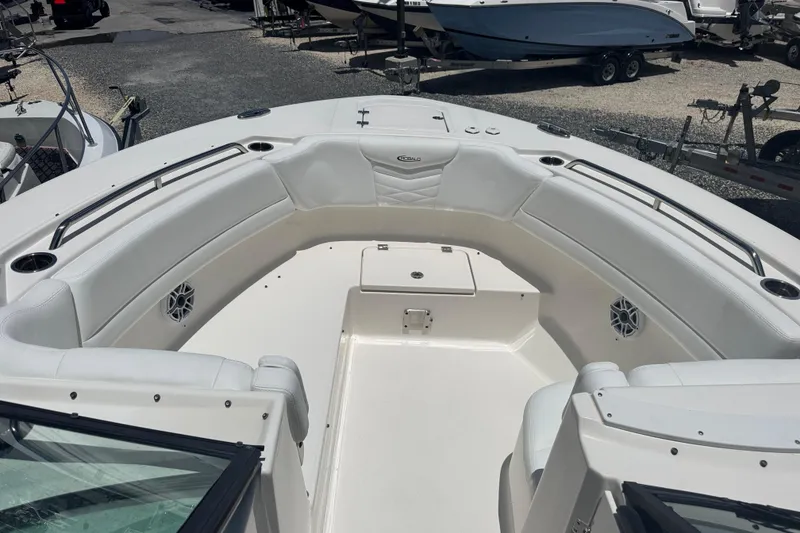 Slide: The Image of 2021 Robalo R317 Dual Console boat with spacious white seating area. - 8