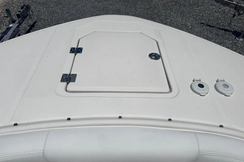 Slide: The Image of 2021 Robalo R317 Dual Console boat deck with storage hatch and fittings. - 9