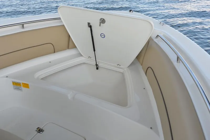 Slide: The Image of Manufacturer Provided Image: 2020 NauticStar 20 XS Offshore boat storage compartment open on calm water. - 15
