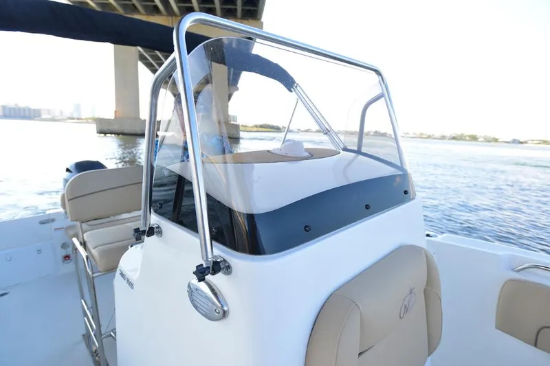 Slide: The Image of Manufacturer Provided Image: 2020 NauticStar 20 XS Offshore boat console and seating under a bridge. - 16