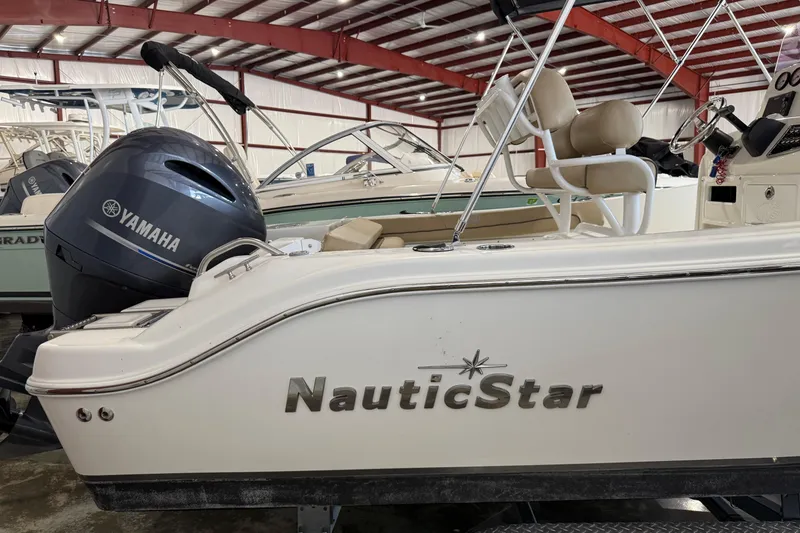 Slide: The Image of 2020 NauticStar 20 XS Offshore boat with Yamaha engine in indoor storage. - 2