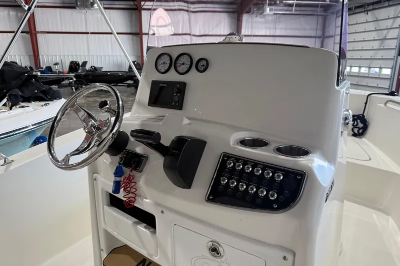 Slide: The Image of 2020 NauticStar 20 XS Offshore boat console with steering wheel and control panel. - 3