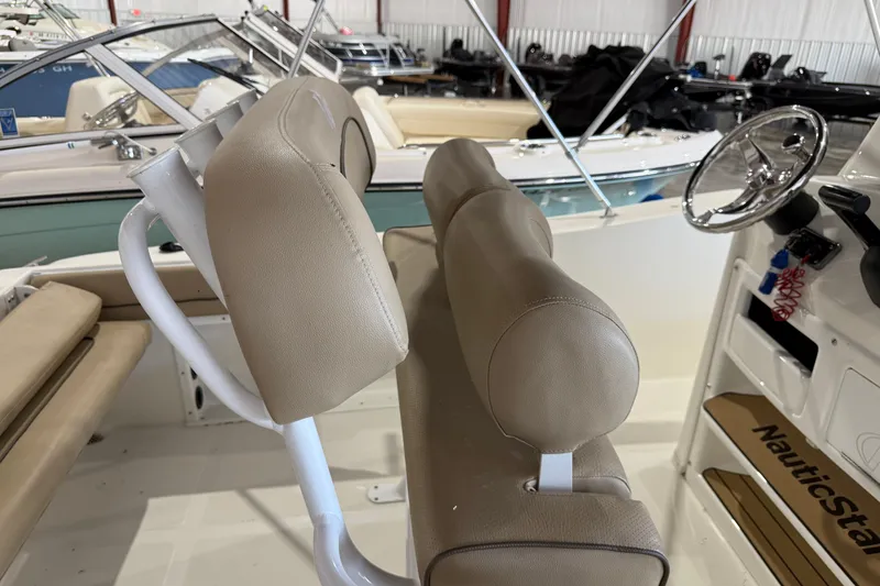 Slide: The Image of 2020 NauticStar 20 XS Offshore boat interior with beige seating and steering wheel. - 4