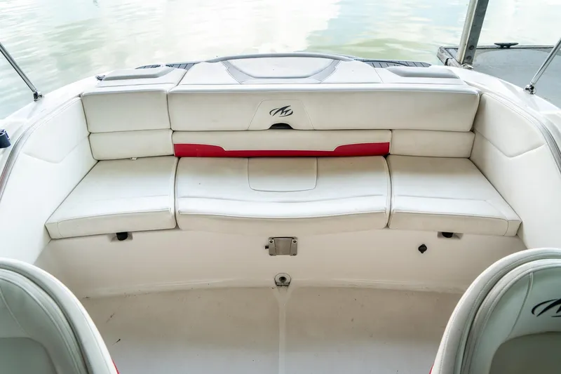 Slide: The Image of 2013 Monterey 204FS boat interior with white seating and red accents. - 11