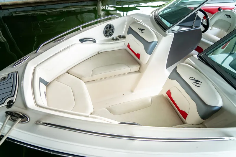 Slide: The Image of Interior of a 2013 Monterey 204FS boat with white and red seating. - 18