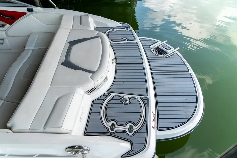 Slide: The Image of 2013 Monterey 204FS boat with sleek seating and swim platform on calm water. - 9