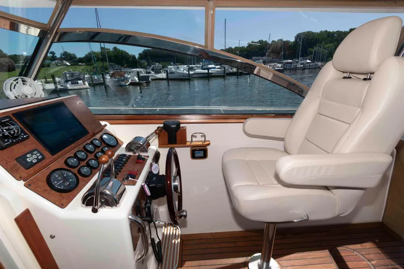 Slide: The Image of Interior helm of 1998 Sabre 36 Hardtop Express with leather seat and control panel. - 11