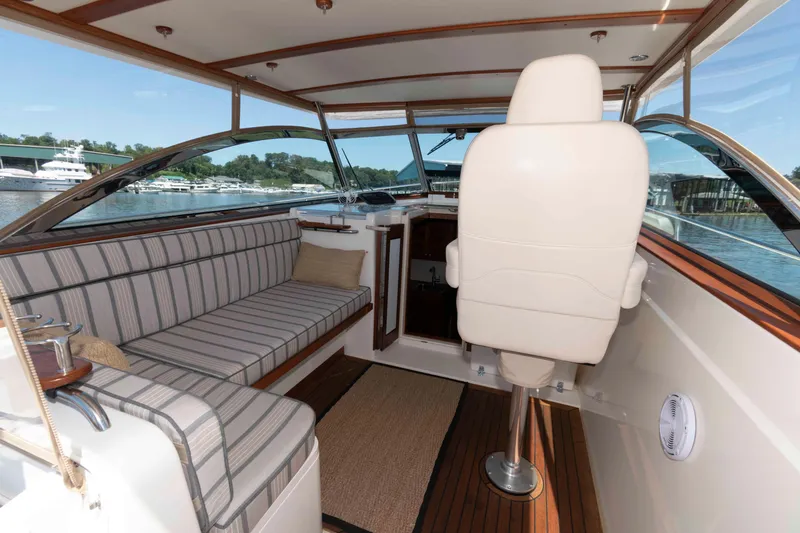Slide: The Image of Interior of 1998 Sabre 36 Hardtop Express yacht with striped seating and helm chair. - 14