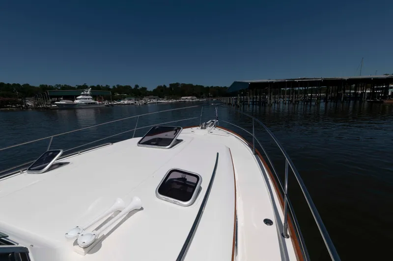 Slide: The Image of Bow view of 1998 Sabre 36 Hardtop Express yacht in marina setting. - 15