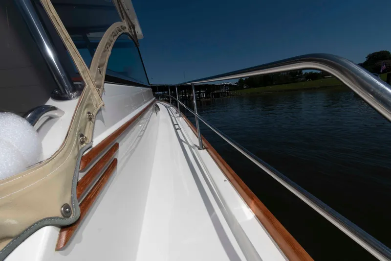 Slide: The Image of Sabre 36 Hardtop Express 1998 boat deck with railing, cruising on calm water. - 16