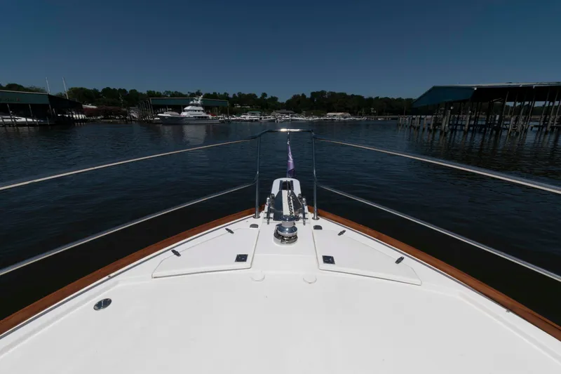 Slide: The Image of Bow view of 1998 Sabre 36 Hardtop Express yacht in marina setting. - 18