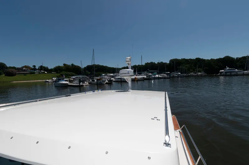 Slide: The Image of Sabre 36 Hardtop Express 1998 on water near marina, clear sky, Garmin equipment visible. - 19