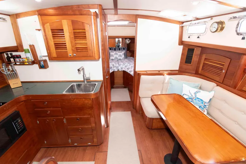 Slide: The Image of Interior of 1998 Sabre 36 Hardtop Express yacht with wood finish and cozy seating area. - 20