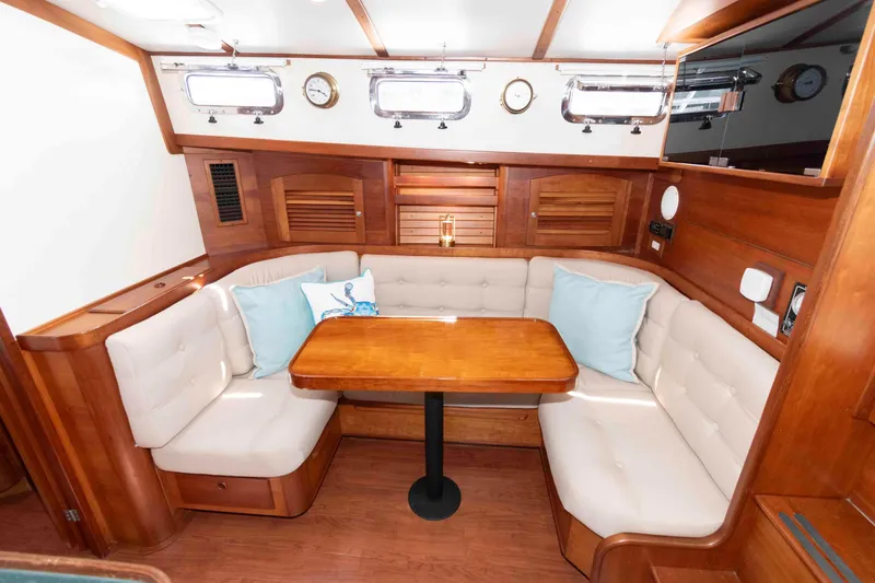 Slide: The Image of Interior of 1998 Sabre 36 Hardtop Express with cozy seating and wooden table. - 21