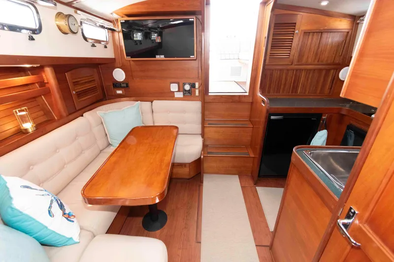 Slide: The Image of Luxurious interior of 1998 Sabre 36 Hardtop Express yacht with wood finish and cozy seating. - 23