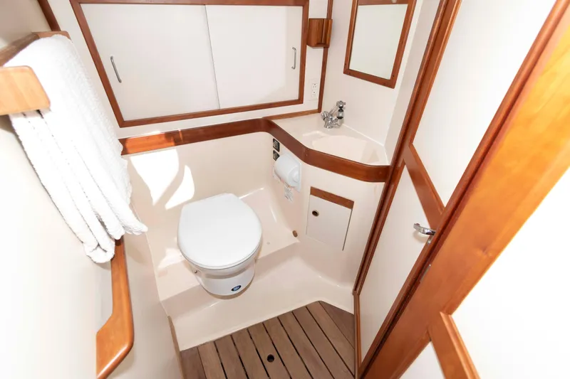 Slide: The Image of 1998 Sabre 36 Hardtop Express bathroom with wooden accents and compact design. - 25