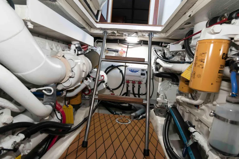 Slide: The Image of Engine room of 1998 Sabre 36 Hardtop Express with visible machinery and equipment. - 26