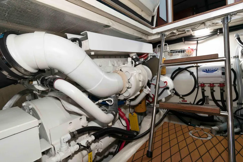 Slide: The Image of Engine room of 1998 Sabre 36 Hardtop Express with visible machinery and ladder. - 27