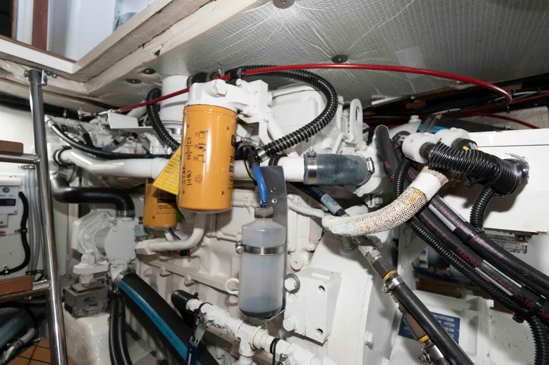 Slide: The Image of Engine room of 1998 Sabre 36 Hardtop Express with visible filters and wiring. - 28