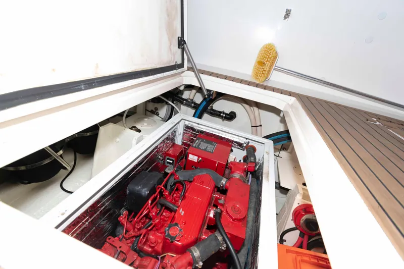 Slide: The Image of Engine compartment of 1998 Sabre 36 Hardtop Express with red engine components. - 30