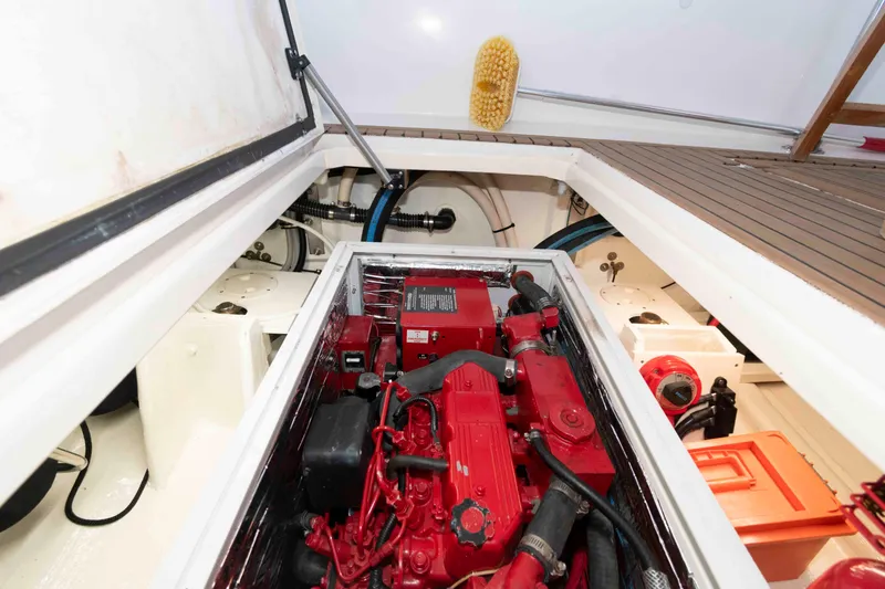 Slide: The Image of Engine compartment of a 1998 Sabre 36 Hardtop Express boat, featuring a red engine. - 31