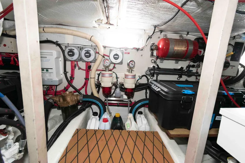 Slide: The Image of Engine room of 1998 Sabre 36 Hardtop Express with equipment and storage containers. - 32