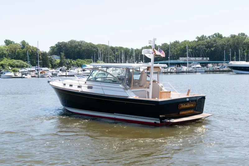Slide: The Image of 1998 Sabre 36 Hardtop Express yacht on water near marina. - 4